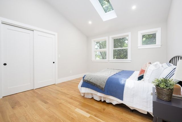 a bedroom with a bed and window