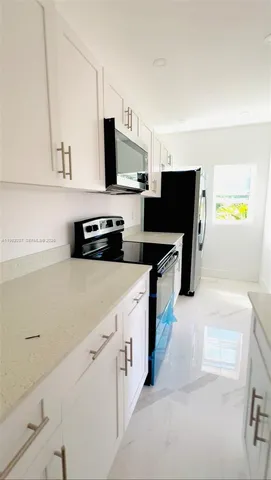 a kitchen with stainless steel appliances a stove and a refrigerator