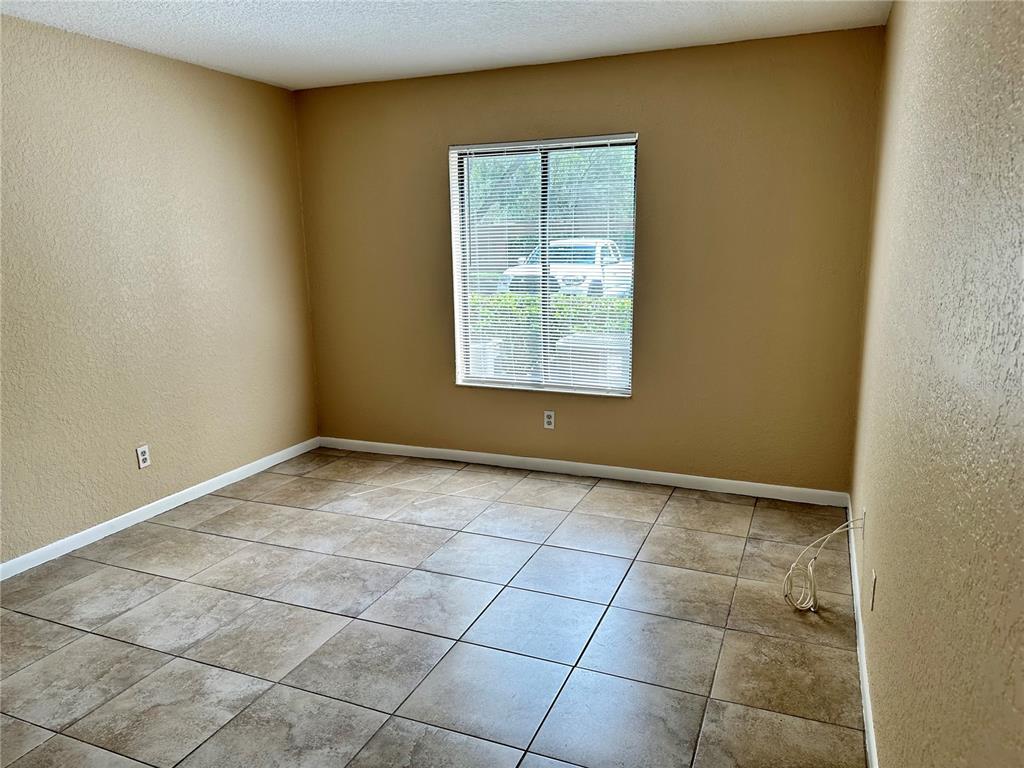 8205 Sun Spring Circle, Unit B1 Orlando, FL 32825 - Photo 7 of 14 a view of a livingroom with an empty space and a window