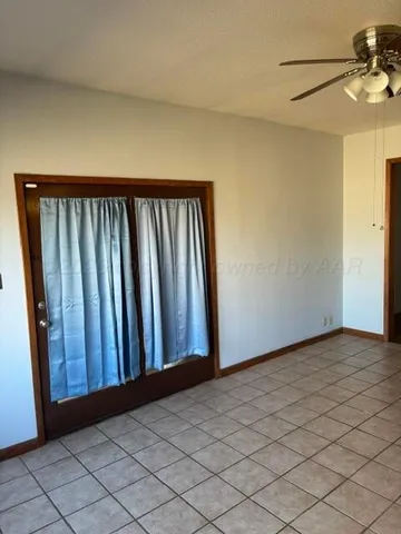 a view of a livingroom with wooden floor and a window