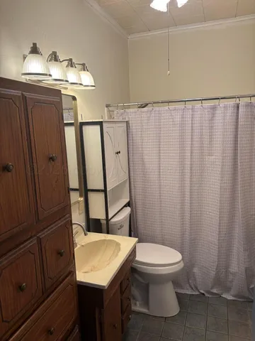 a white toilet sitting next to a bathroom sink