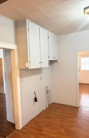 a view of a kitchen with wooden floor