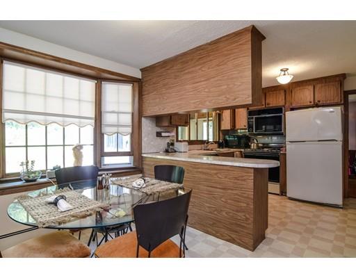 42 Larnis Road Framingham, MA 01701 - Photo 11 of 25 a kitchen with a dining table chairs and refrigerator