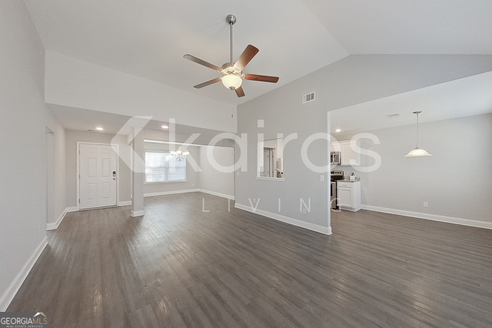 228 Western Red Cedar Drive Springfield, GA 31329 - Photo 5 of 27 an empty room with wooden floor fan and windows