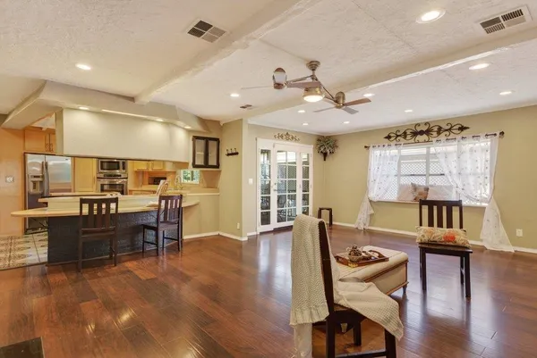 a living room with furniture and wooden floor
