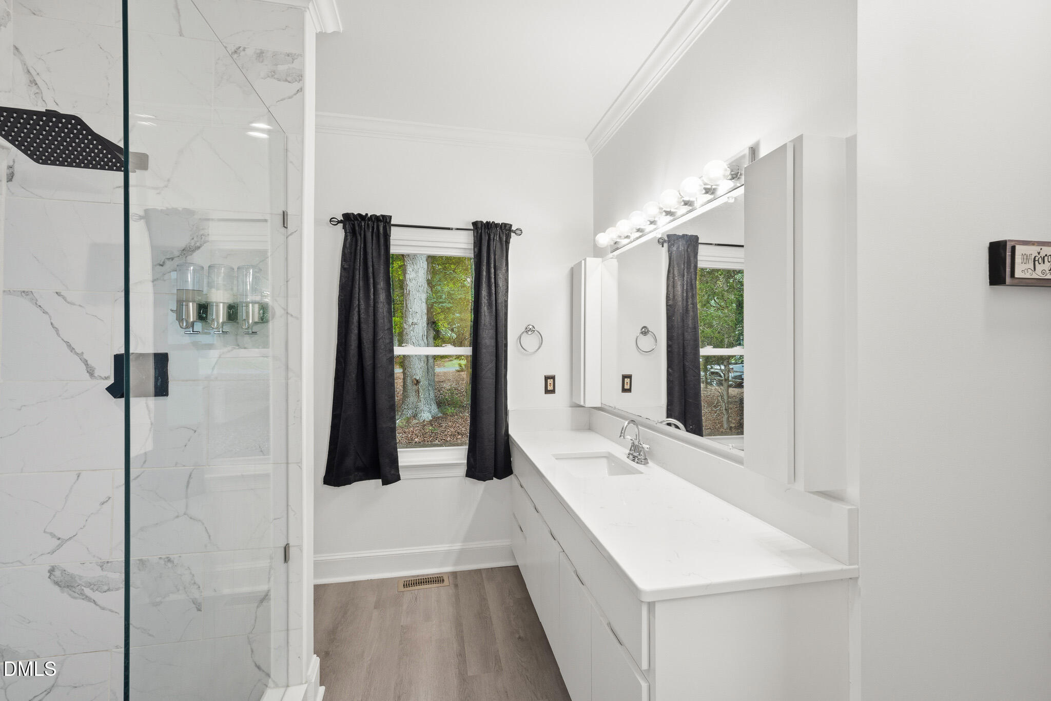 3735 Stoneybrook Drive Durham, NC 27705 - Photo 26 of 44 a bathroom with a sink and mirror