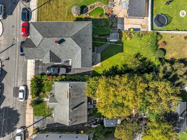 an aerial view of a house with a yard