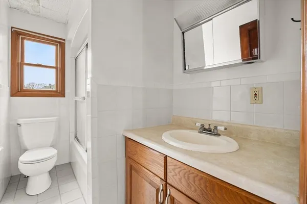 a bathroom with a sink toilet and a mirror