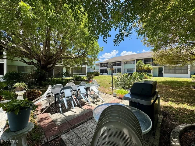a view of a patio with couches chairs and a fire pit