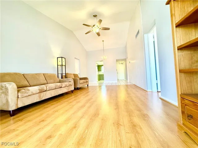 a living room with a bed furniture and a large window