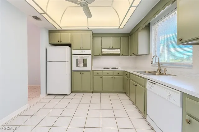 a kitchen with a sink a refrigerator and washer