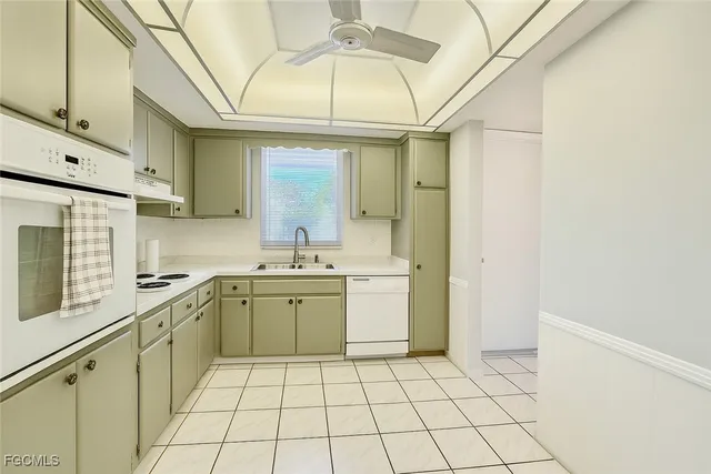 a kitchen with a sink cabinets and appliances