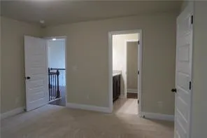 an empty room with closet and mirror