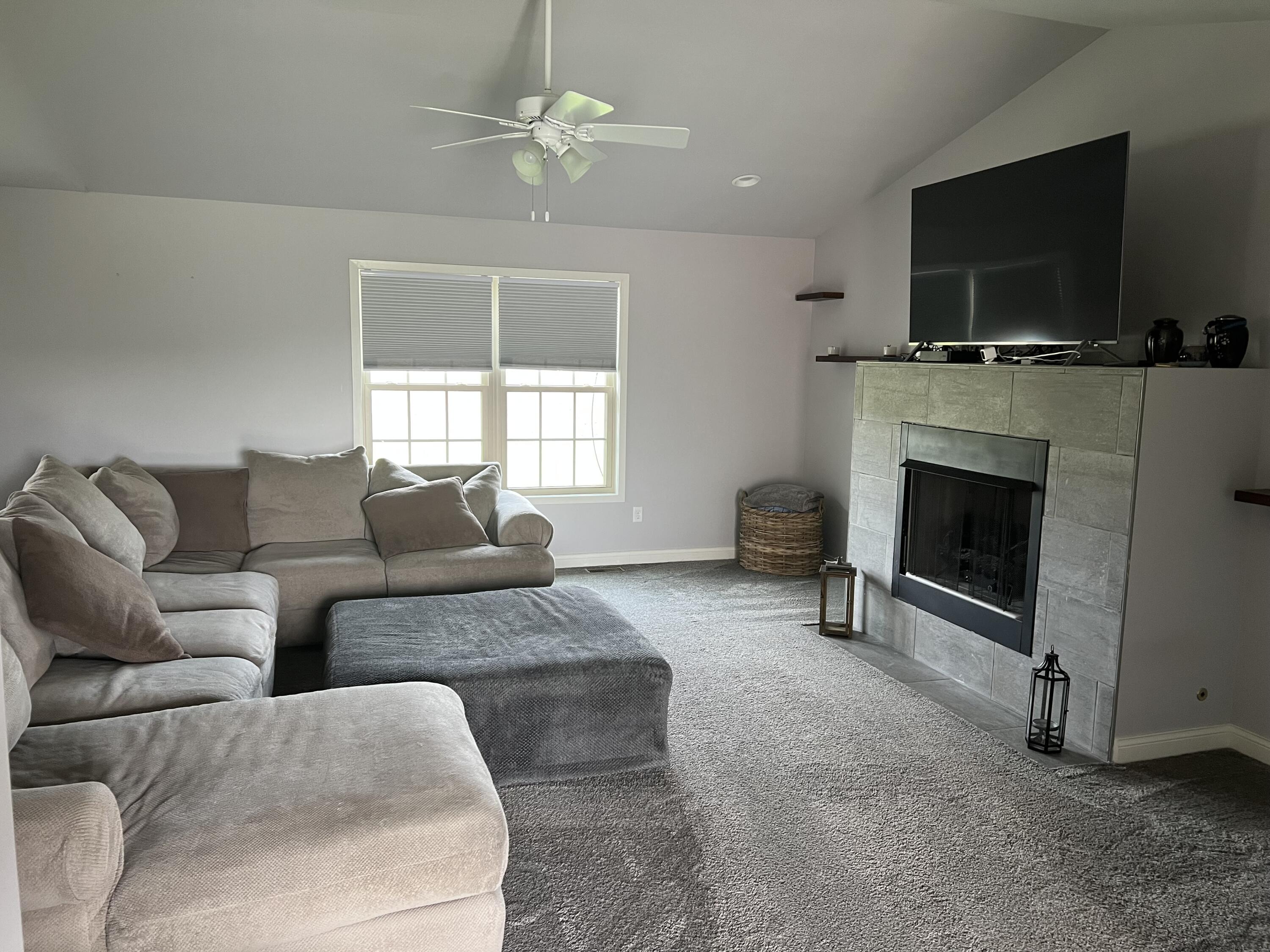 702 19th Street Southeast De Motte, IN 46310 - Photo 3 of 22 a living room with furniture a fireplace and a flat screen tv