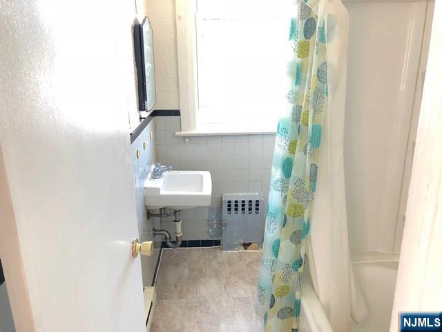 82 Park Avenue, Unit 1 Rutherford, NJ 07070 - Photo 6 of 6 a bathroom with a sink and a mirror