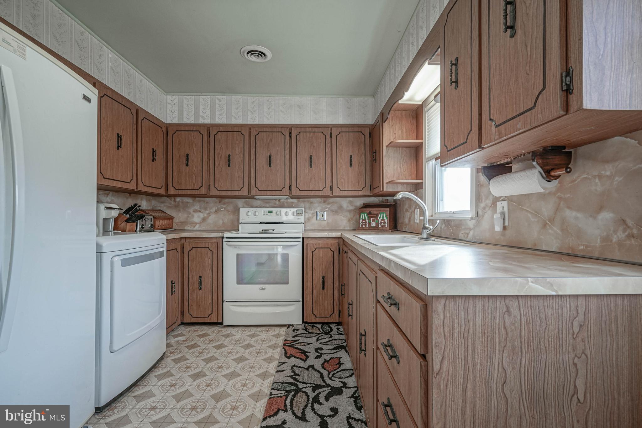 249 Cleveland Avenue Carneys Point, NJ 08069 - Photo 12 of 52 a kitchen with a sink stove and cabinets