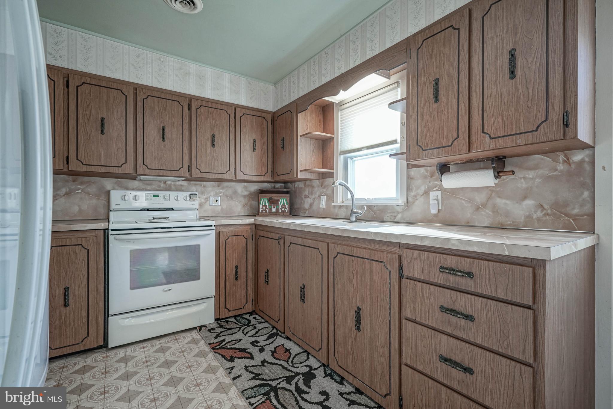 249 Cleveland Avenue Carneys Point, NJ 08069 - Photo 14 of 52 a kitchen with cabinets appliances a sink and a window