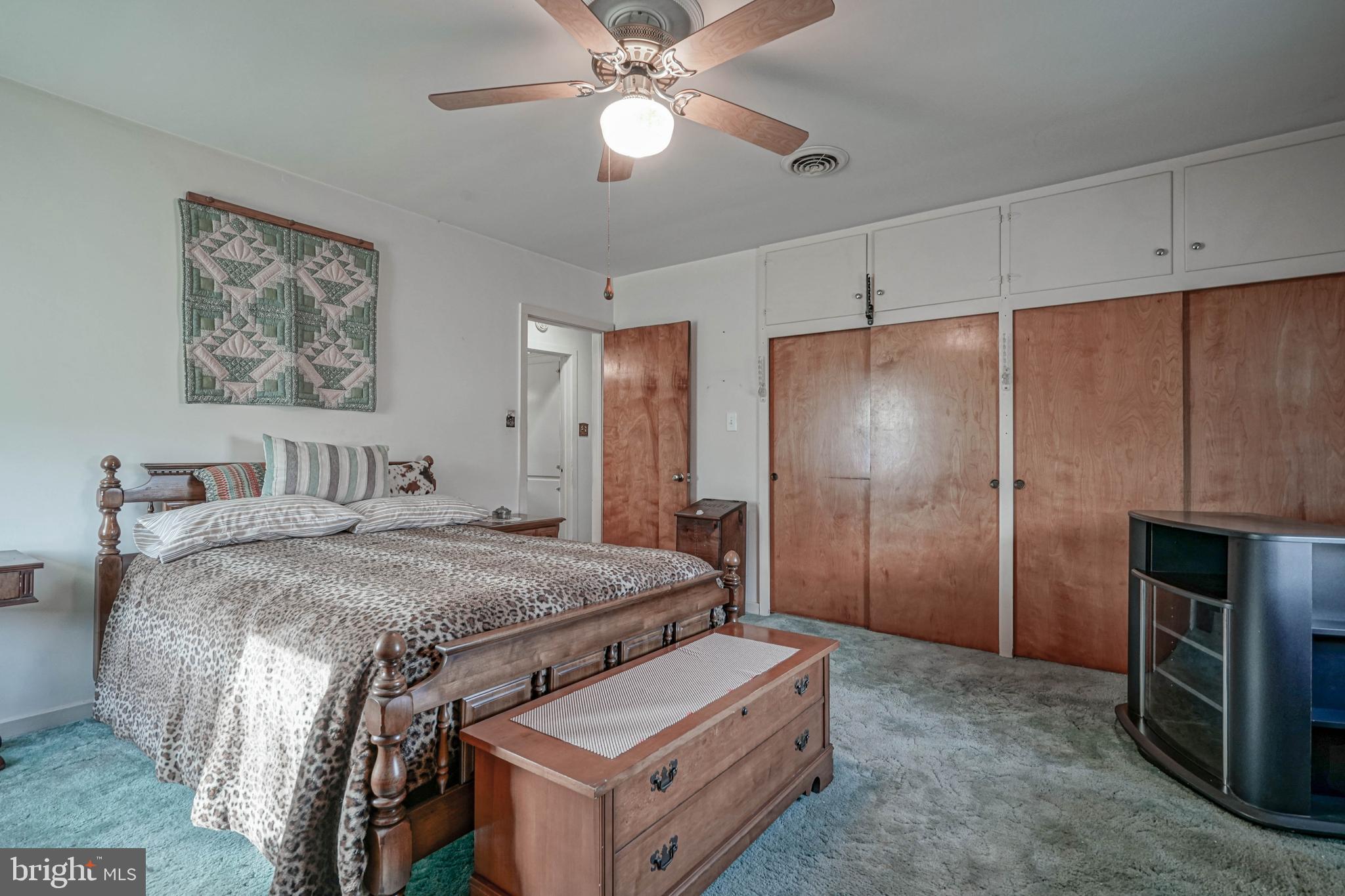 249 Cleveland Avenue Carneys Point, NJ 08069 - Photo 16 of 52 a spacious bedroom with a bed and a chandelier