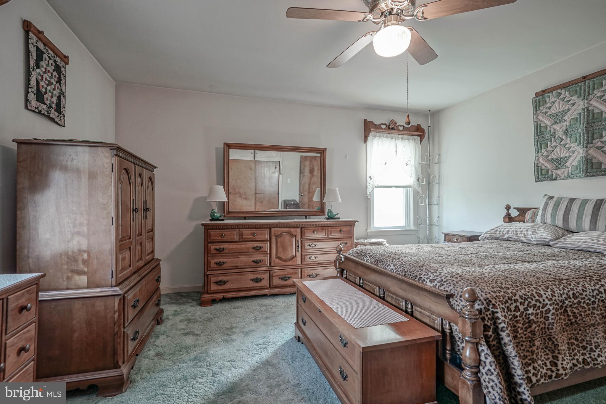 249 Cleveland Avenue Carneys Point, NJ 08069 - Photo 17 of 52 a bedroom with a bed and a chandelier