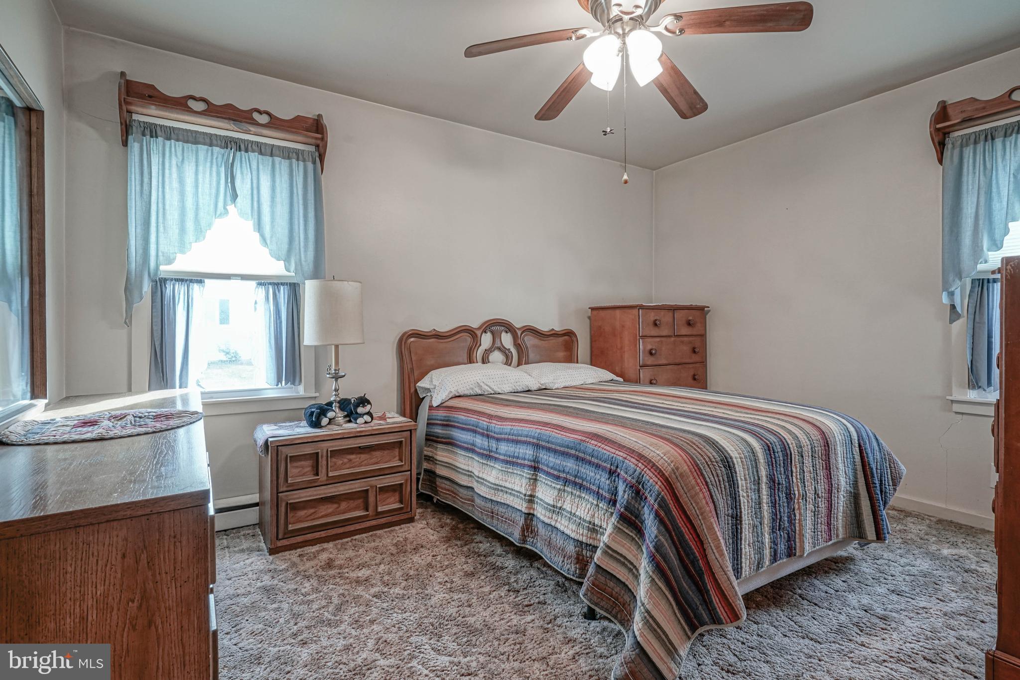 249 Cleveland Avenue Carneys Point, NJ 08069 - Photo 19 of 52 a bedroom with a bed and a chandelier