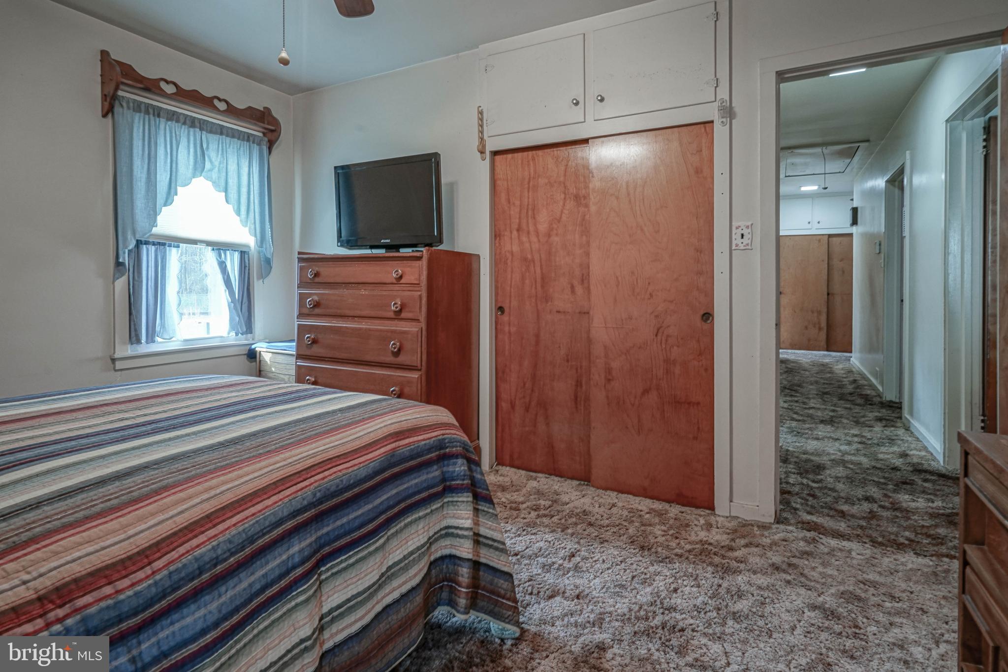 249 Cleveland Avenue Carneys Point, NJ 08069 - Photo 20 of 52 a bedroom with a bed and a flat tv screen on dresser