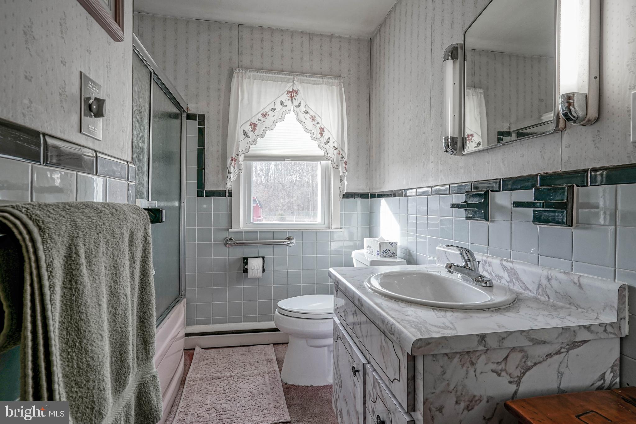 249 Cleveland Avenue Carneys Point, NJ 08069 - Photo 21 of 52 a bathroom with a sink toilet and mirror