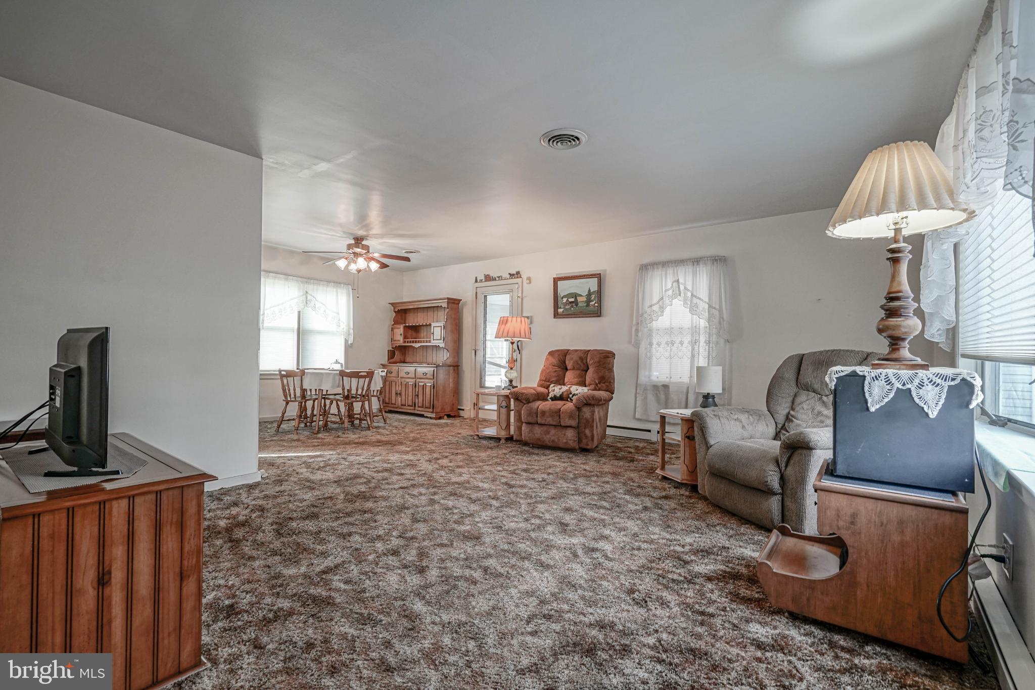 249 Cleveland Avenue Carneys Point, NJ 08069 - Photo 5 of 52 a living room with furniture a window and a flat screen tv