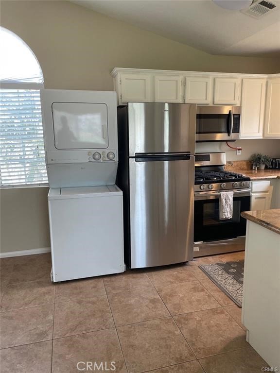 12934 Arapaho Road, Unit A Rancho Cucamonga, CA 91739 - Photo 4 of 6 a kitchen with stainless steel appliances granite countertop a refrigerator a stove a sink and a microwave