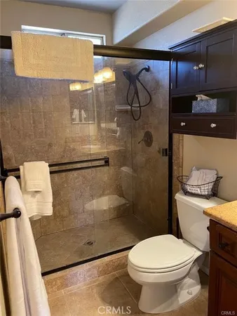 a bathroom with a toilet and a shower