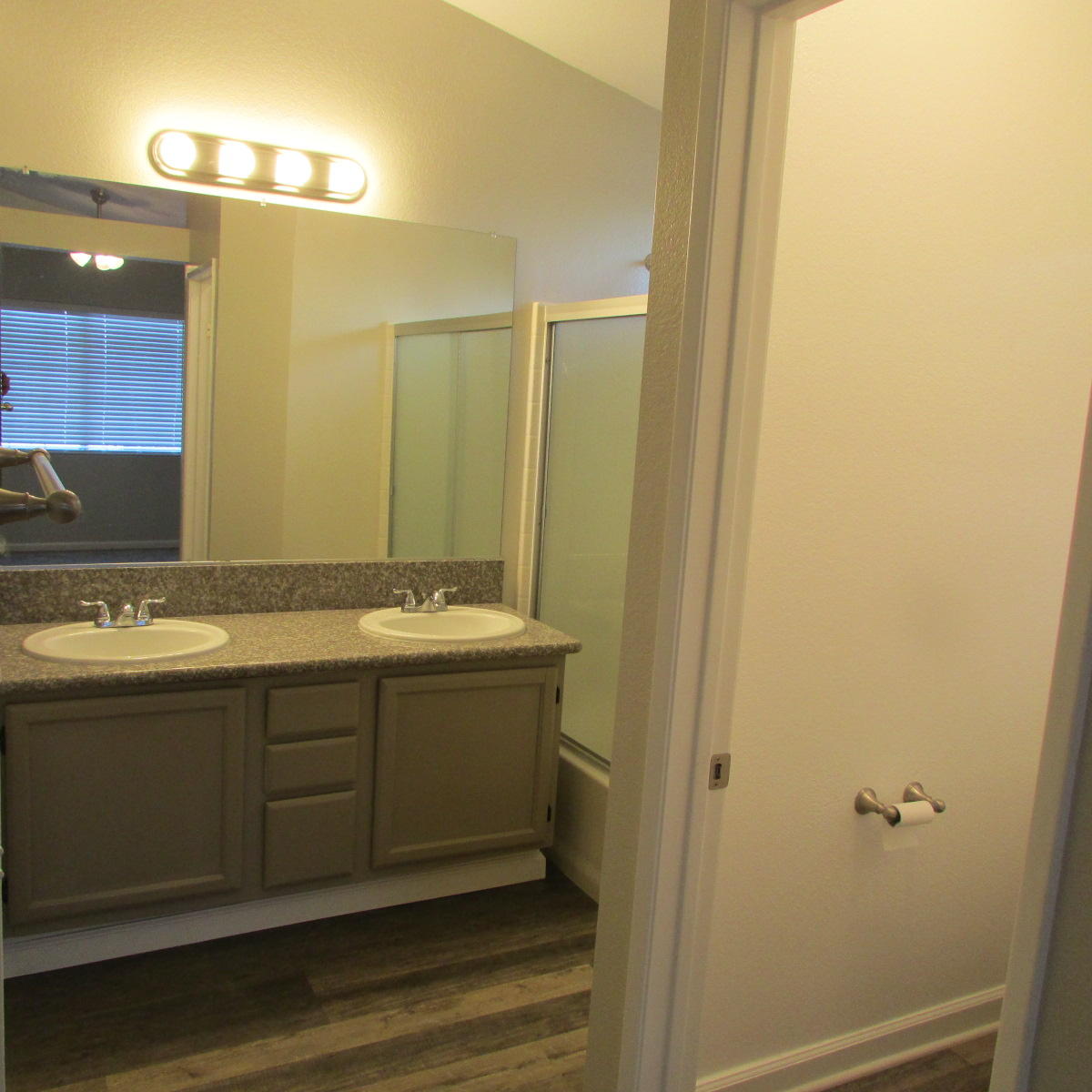 1832 Ivory Avenue Palmdale, CA 93550 - Photo 24 of 52 a bathroom with a double vanity sink and mirror