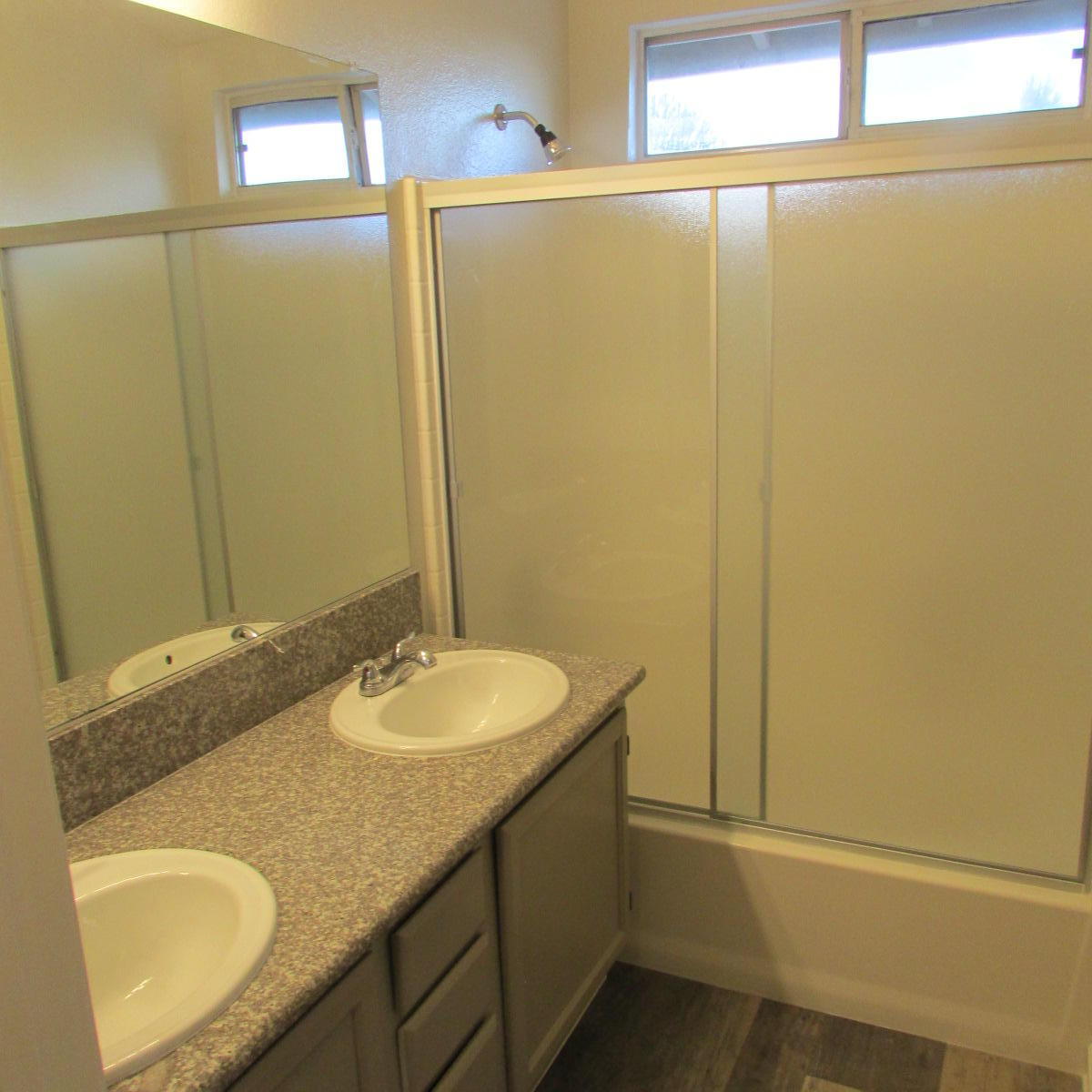 1832 Ivory Avenue Palmdale, CA 93550 - Photo 27 of 52 a bathroom with a granite countertop sink and a mirror