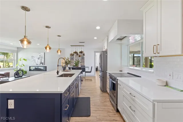 a kitchen with sink stove and cabinets