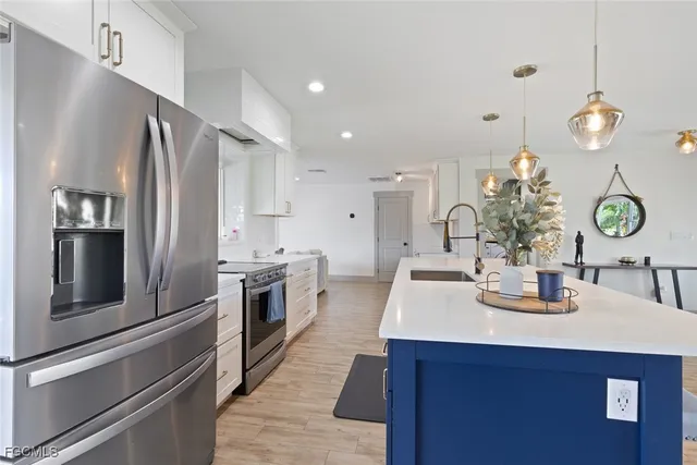 a kitchen with a sink and refrigerator