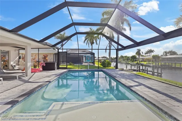 a view of a swimming pool with a lounge chairs in a balcony