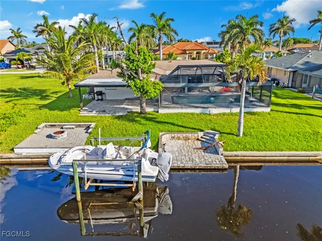 a view of a patio with table and chairs and potted plants