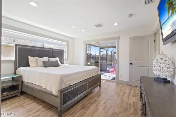 a bedroom with bed and wooden floor