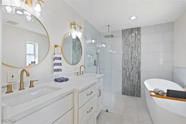 a bathroom with a double vanity sink mirror and shower