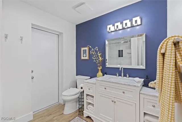 a bathroom with a toilet a sink and a mirror