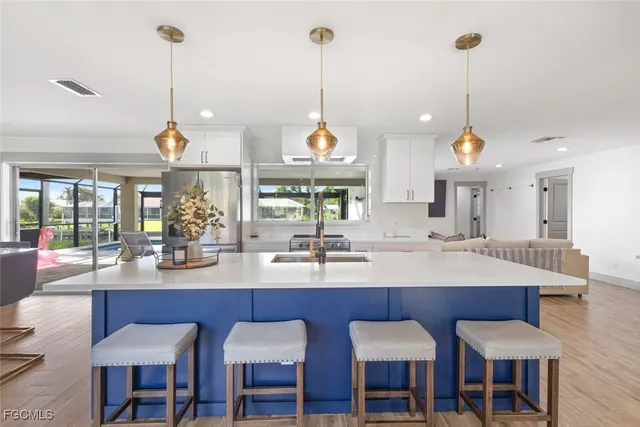 a kitchen with a dining table chairs and white floor