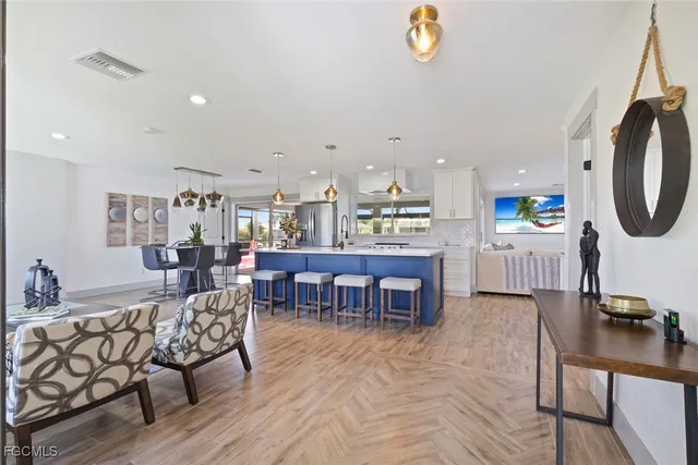 a living room with furniture a dining table and a window