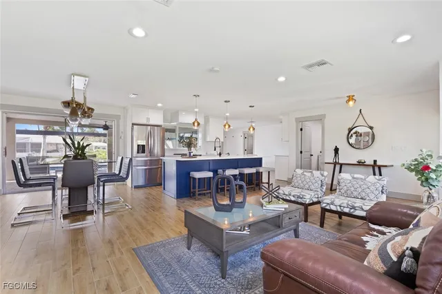 a living room with lots of furniture and kitchen view