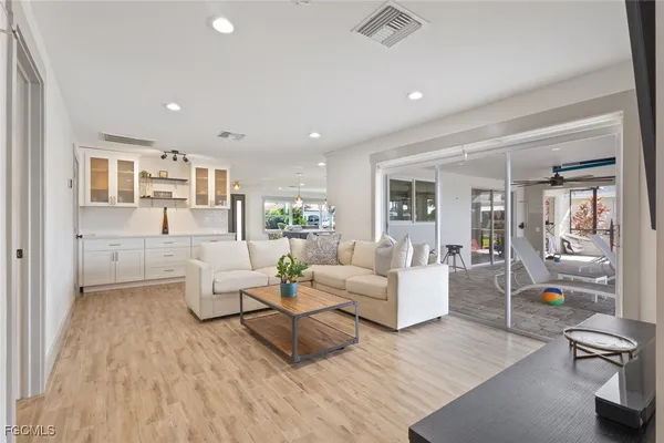 a living room with furniture and a wooden floor