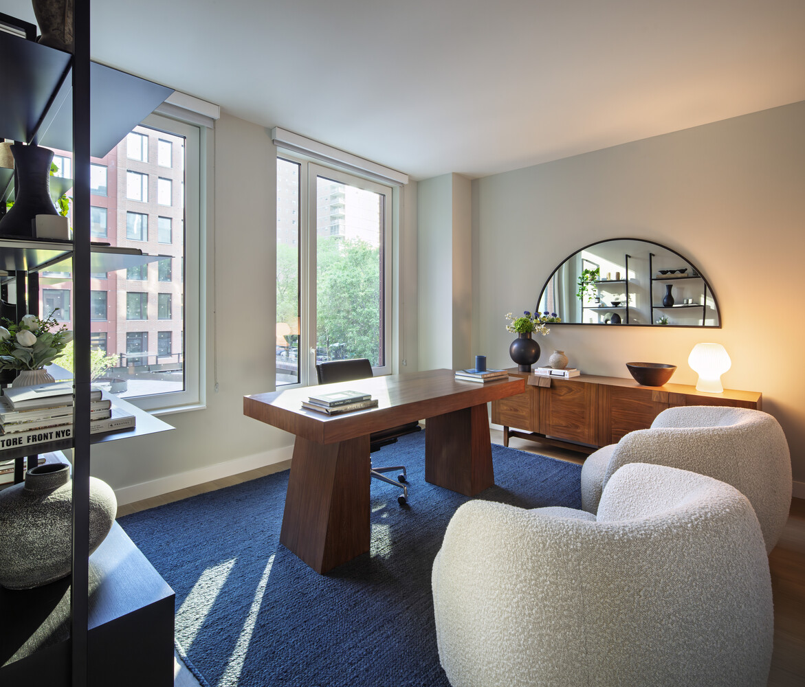 335 8th Avenue, Unit 621 Manhattan, NY 10001 - Photo 2 of 13 a living room with furniture and a large window