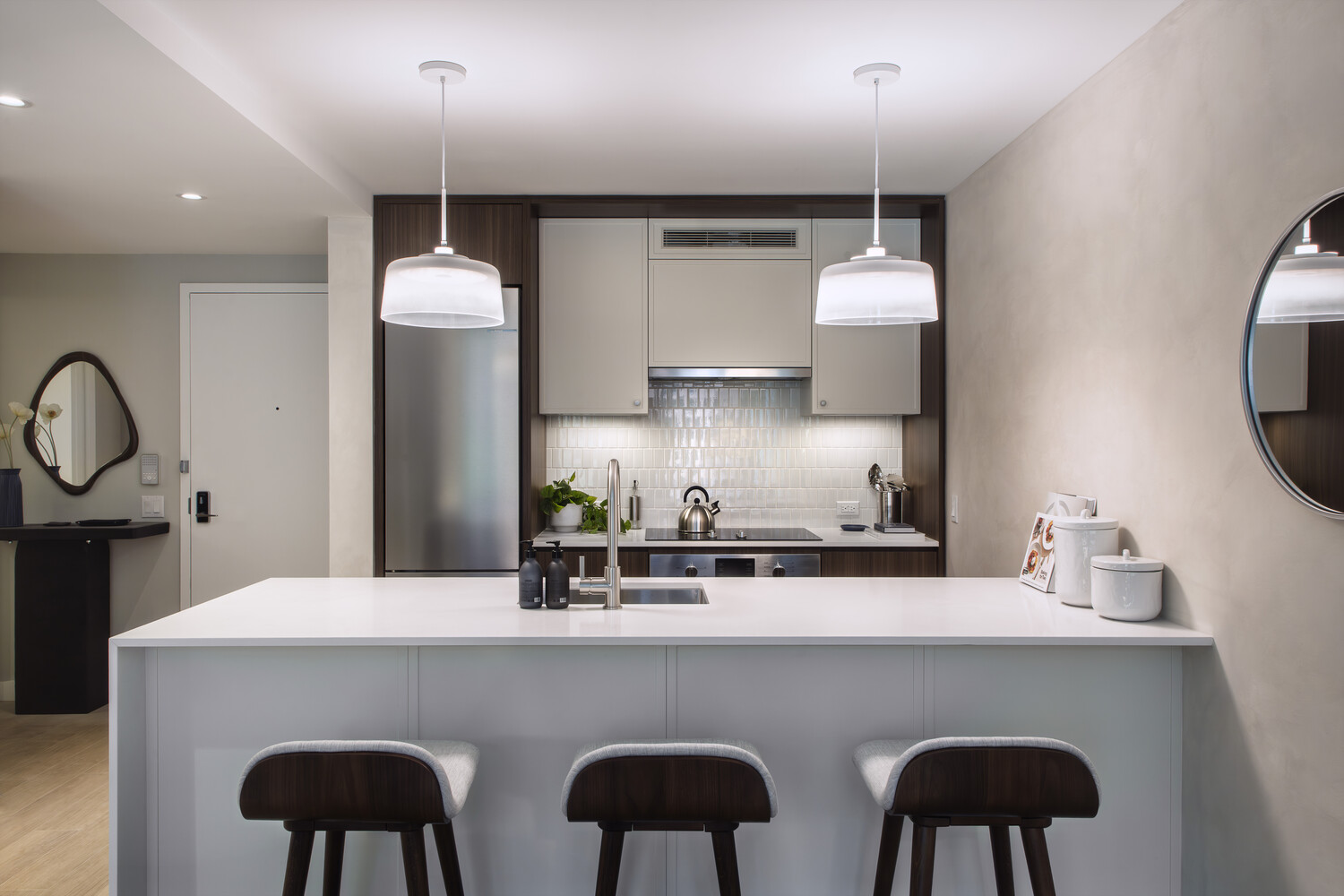 335 8th Avenue, Unit 621 Manhattan, NY 10001 - Photo 5 of 13 a kitchen with stainless steel appliances a sink cabinets and a wooden floor