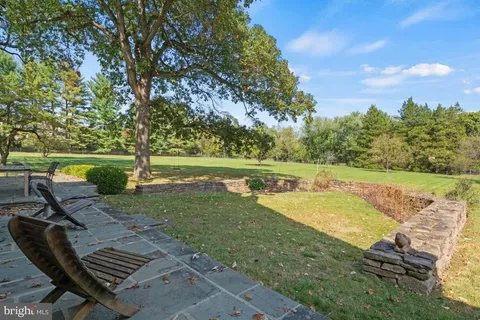 a view of a house with swimming pool and a yard