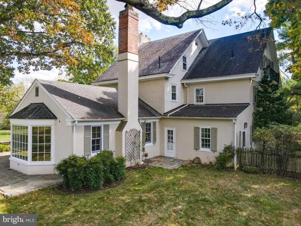 665 Lewis Lane Blue Bell, PA 19422 - Photo 10 of 14 a view of a yard in front of a house with plants and large tree