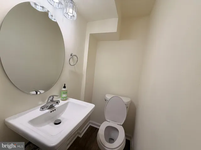 a bathroom with a sink mirror and toilet