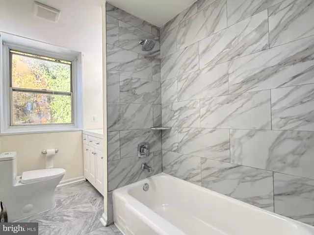 a bathroom with a bathtub and window