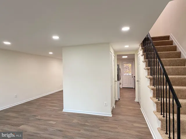 a view of a hallway with wooden floor