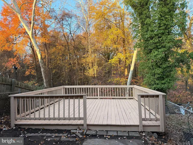 a view of a roof deck with wooden floor and fence